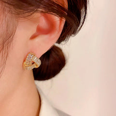 Close-up detail of the sparkling zircons and plating on the Triangle Stud Earrings