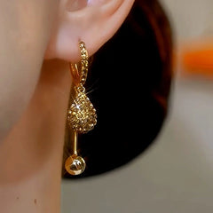 Model showcasing the dangle and style of the 14K Gold-plated Zircon Water Drop Earrings