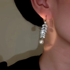 Model showcasing the dangle and style of the 14K Gold-plated Zircon Wheat Pearl Tassel Ear Hook Earrings