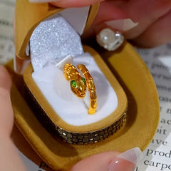 Close-up view of the gemstone and setting of the Gold Snake Ring