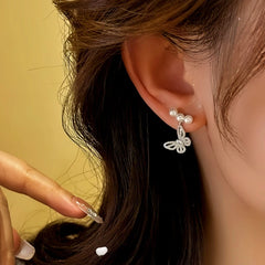 Model showcasing the dangle and style of the Zircon Butterfly Dangle Earrings | 14K Gold Plated