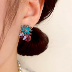 Close-up detail of the sparkling zircons and plating on the gold flower earrings