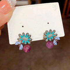 Angled view of the 14K Gold Plated Bee Petal Flower Purple Bead Earrings