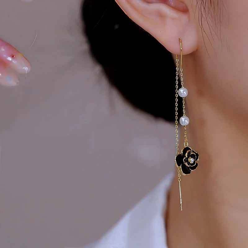 Angled view of the 14K Gold Plated Brown Camellia Threader Tassel Earrings