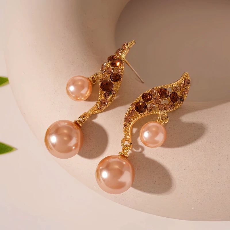 Model showcasing the dangle and style of the 14K Gold Plated Brown Diamond Pearl Earrings