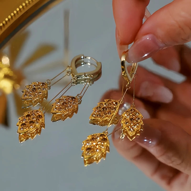 Angled view of the 14K Gold Plated Brown Zircon Wheat Tassel Earrings