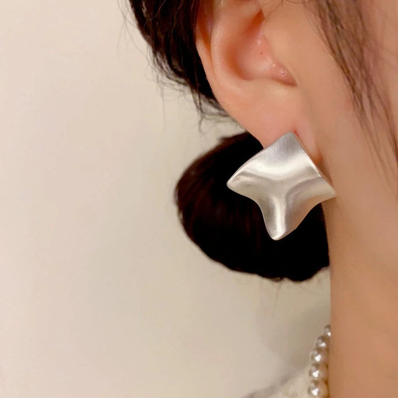 Model showcasing the dangle and style of the 14K Gold Plated Brushed Earrings