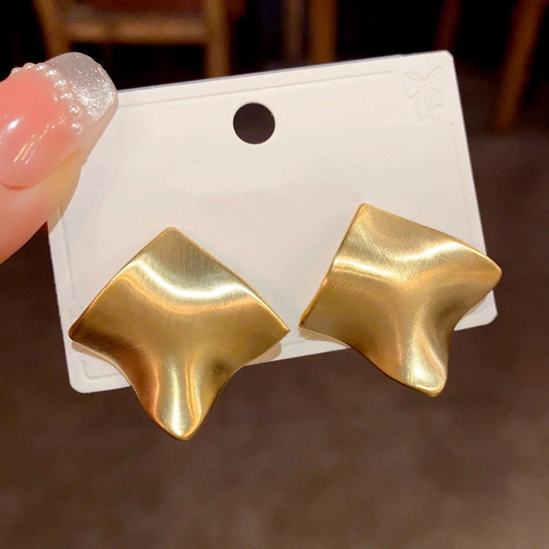 Close-up detail of the sparkling zircons and plating on the gold drop earrings