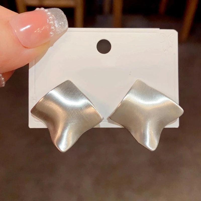 Angled view of the 14K Gold Plated Brushed Earrings