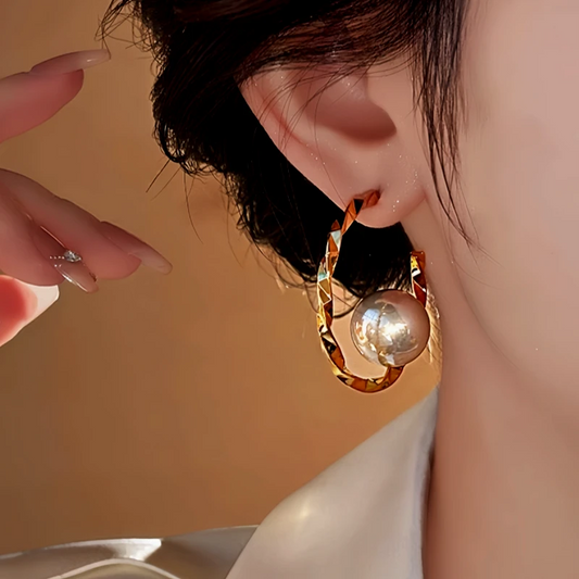 Model showcasing the dangle and style of the 14K Gold Plated C-Shaped Twisted Pearl Earrings