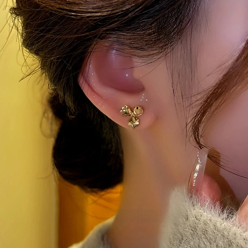 Close-up detail of the sparkling zircons and plating on the gold flower earrings
