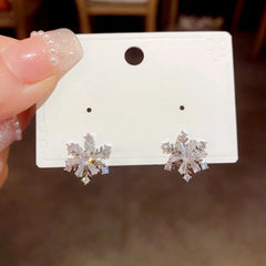 Angled view of the 14K Gold Plated Christmas Rotation Snowflake Stud Earrings
