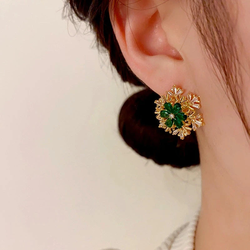 Model showcasing the dangle and style of the 14K Gold Plated Christmas Zircon Rotation Snowflake Stud Earrings