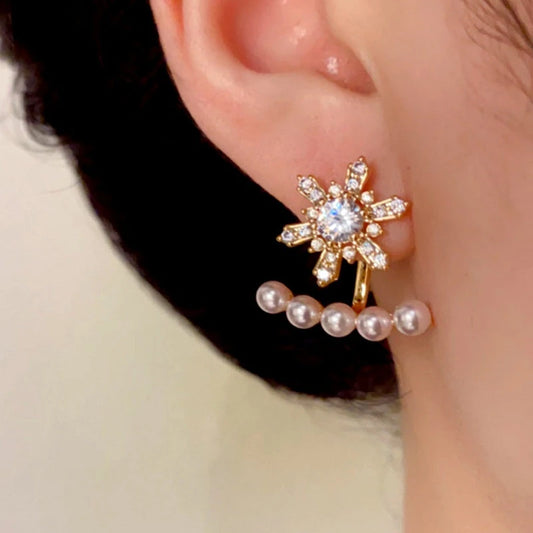 Model showcasing the dangle and style of the 14K Gold Plated Christmas Zircon Snowflake Pearl Two-Piece Earrings