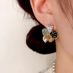 Close-up detail of the sparkling zircons and plating on the gold flower earrings