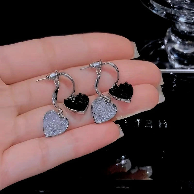 Model showcasing the dangle and style of the 14K Gold Plated Crystal Double-Heart Earrings