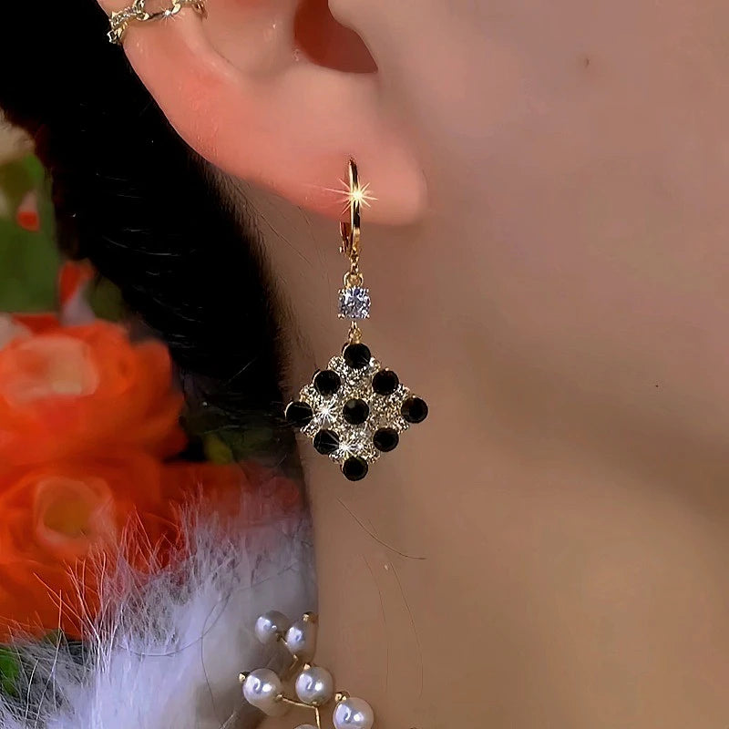 Model showcasing the dangle and style of the 14K Gold Plated Diamond Black And White Water Drop Earrings