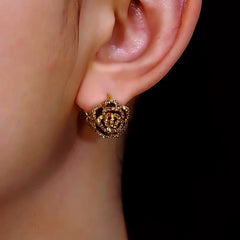 Model showcasing the dangle and style of the 14K Gold Plated Diamond Camellia Earrings