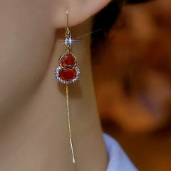 Model showcasing the dangle and style of the 14K Gold Plated Diamond Crystal Gourd Threader Earrings