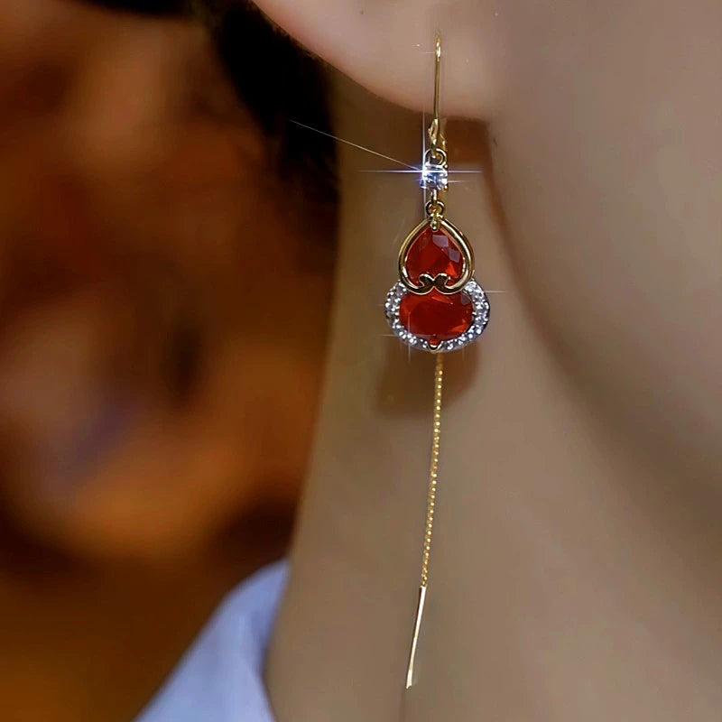 Close-up detail of the sparkling zircons and plating on the gold threader earrings