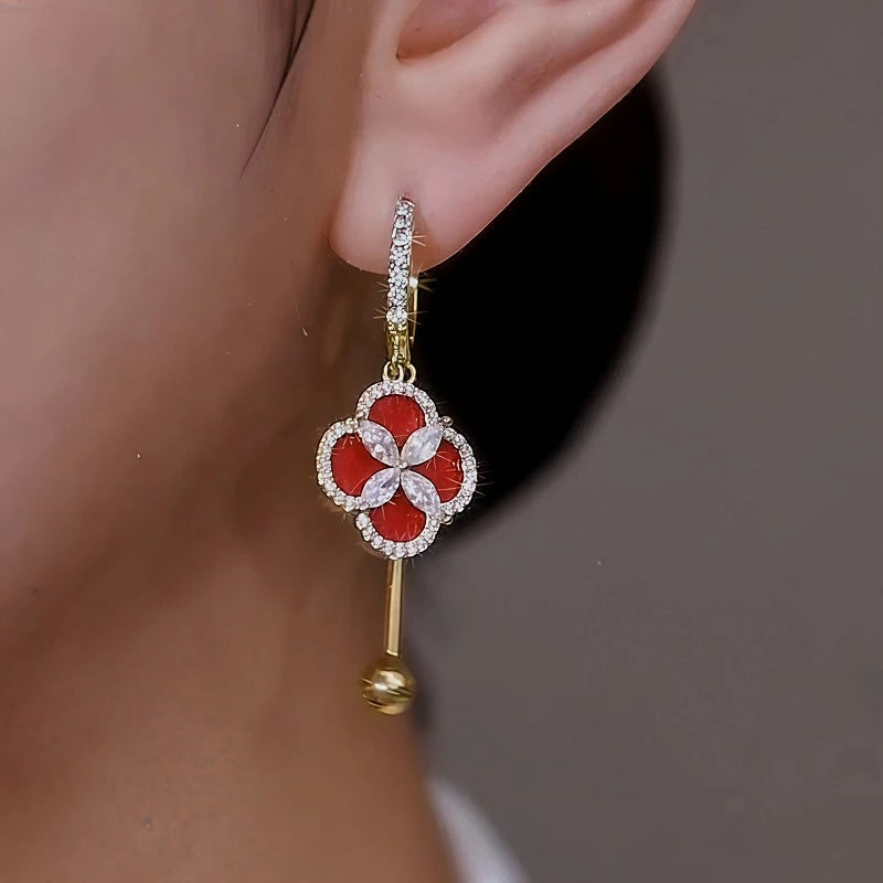 Model showcasing the dangle and style of the 14K Gold Plated Diamond Four-Leaf Clover Earrings