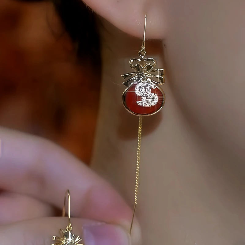 Close-up detail of the sparkling zircons and plating on the gold threader earrings