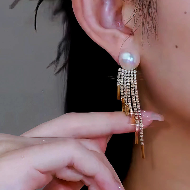 Model showcasing the dangle and style of the 14K Gold-Plated Diamond Pearl Tassel Earrings