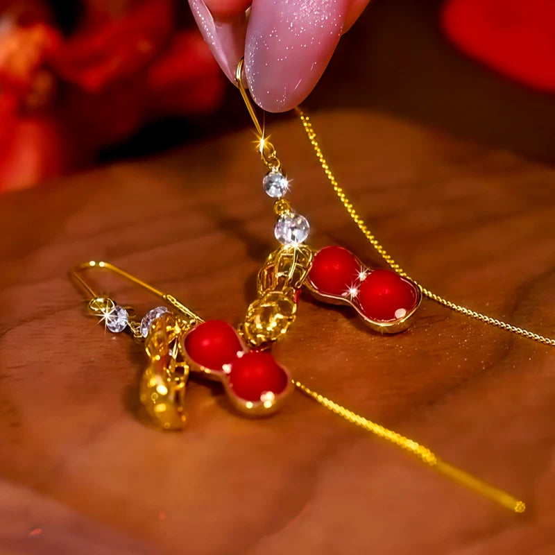 Angled view of the 14K Gold Plated Diamond Red Pearl Peanut Threader Earrings