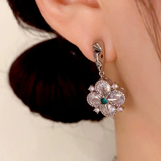 Model showcasing the dangle and style of the 14K Gold Plated Diamond Star Four-Leaf Flower Earrings