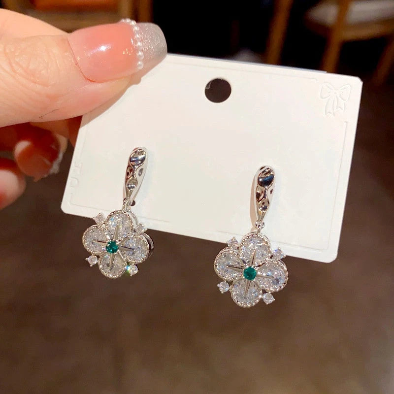 Angled view of the 14K Gold Plated Diamond Star Four-Leaf Flower Earrings