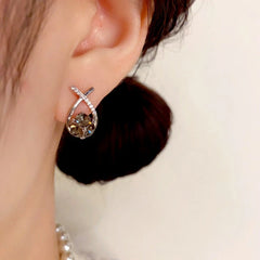 Model showcasing the dangle and style of the 14K Gold Plated Diamond Stud Earrings