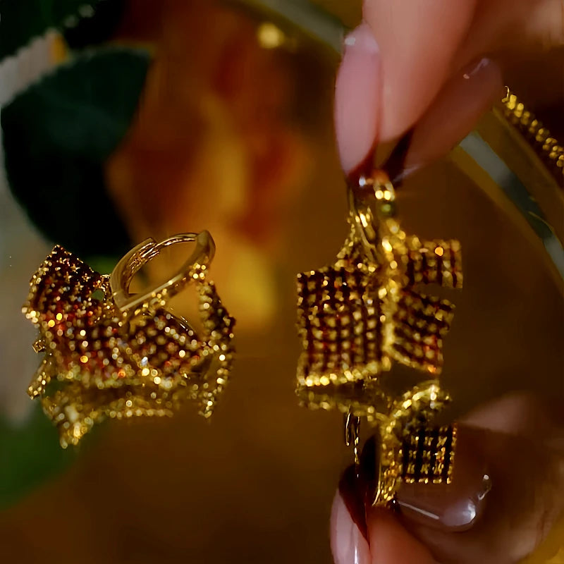 Close-up detail of the sparkling zircons and plating on the gold tassel earrings