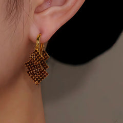 Model showcasing the dangle and style of the 14K Gold Plated Diamond Tassel Earrings