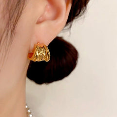 Close-up detail of the sparkling zircons and plating on the gold leaf earrings