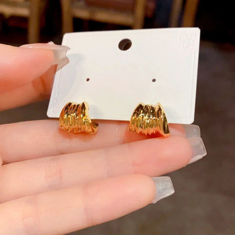 Angled view of the 14K Gold Plated Folded Leaf Earrings