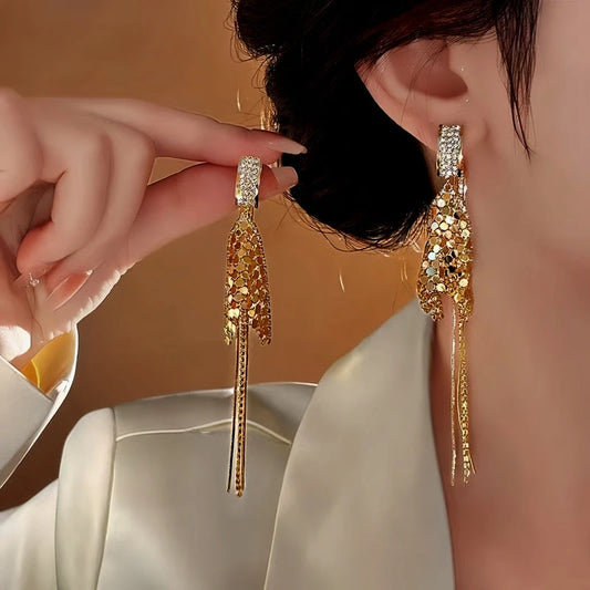 Model showcasing the dangle and style of the 14K Gold Plated Geometric Diamond Tassel Earrings