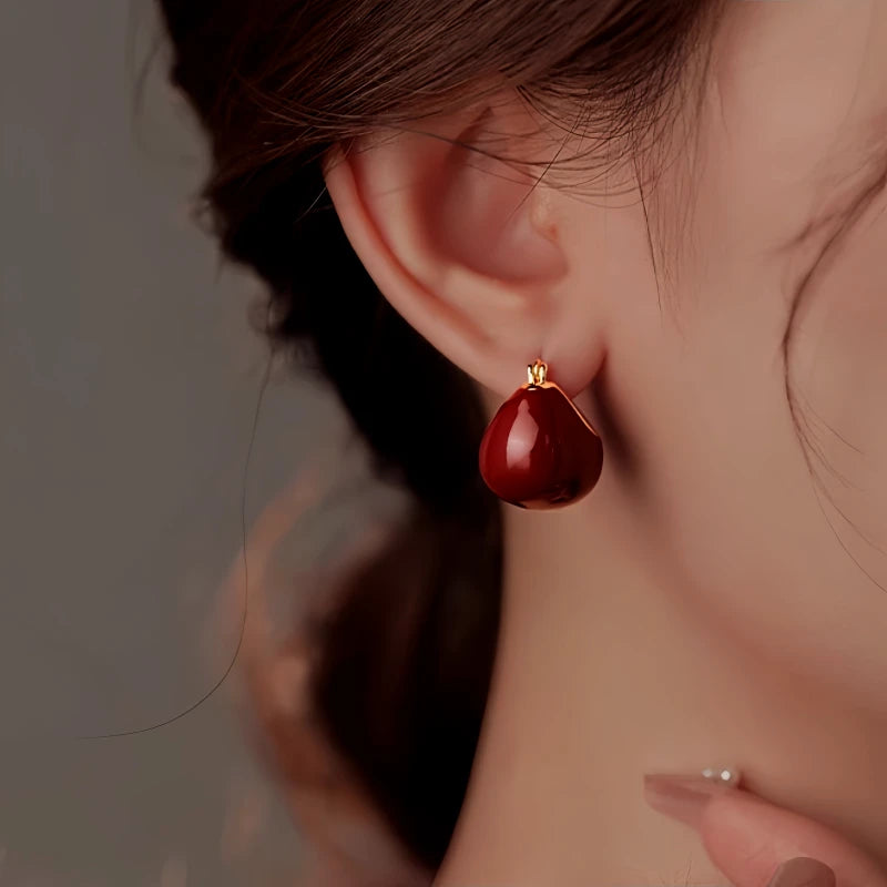 Close-up detail of the sparkling zircons and plating on the red drop earrings