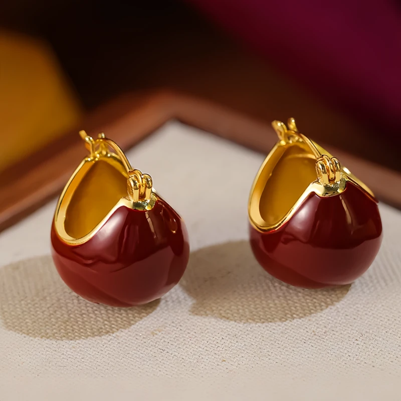 Angled view of the 14K Gold Plated Glaze Wine Red Basket Earrings