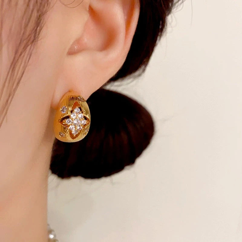 Model showcasing the dangle and style of the 14K Gold Plated Hollow Diamond Earrings