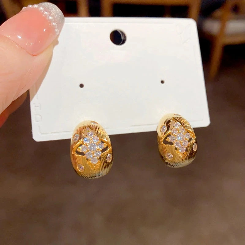 Angled view of the 14K Gold Plated Hollow Diamond Earrings