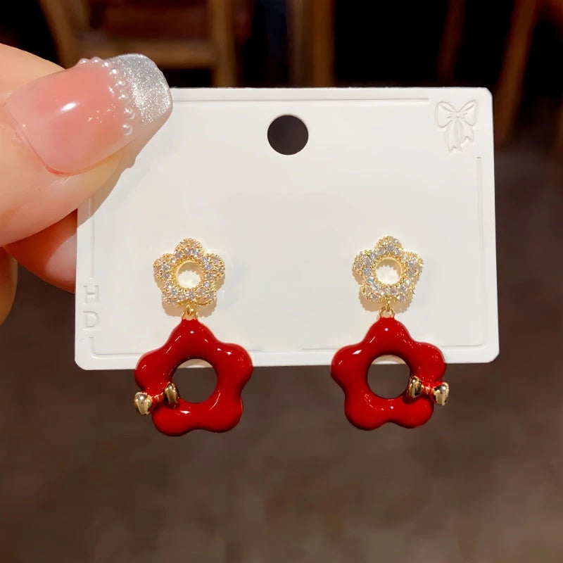 Angled view of the 14K Gold Plated Hollow Petal Flower Earrings