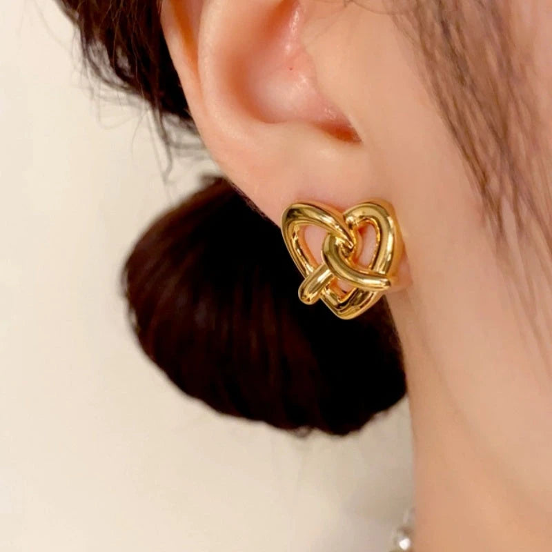 Close-up detail of the sparkling zircons and plating on the gold heart earrings