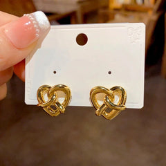 Angled view of the 14K Gold Plated Knotted Love Heart Stud Earrings