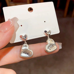 Angled view of the 14K Gold Plated Love Letter Heart Earrings