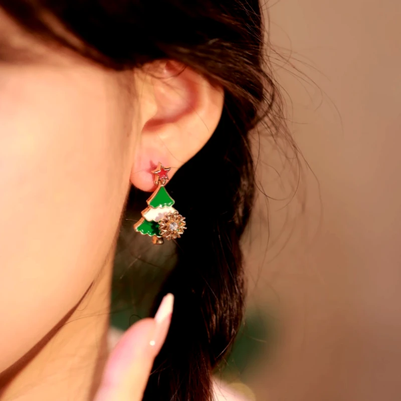 Angled view of the 14K Gold Plated New 2025 Christmas Asymmetrical Rotating Snowflake Christmas Tree Earrings