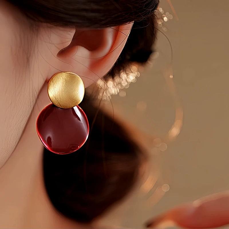Close-up detail of the sparkling zircons and plating on the gold drop earrings