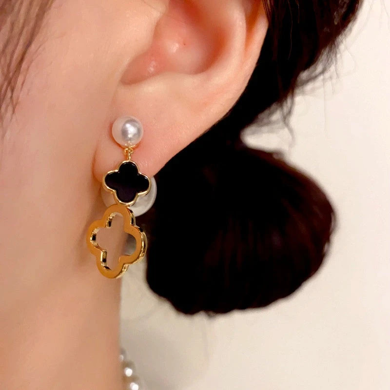 Model showcasing the dangle and style of the 14K Gold Plated Pearl Four-Leaf Flower Front And Back Earrings