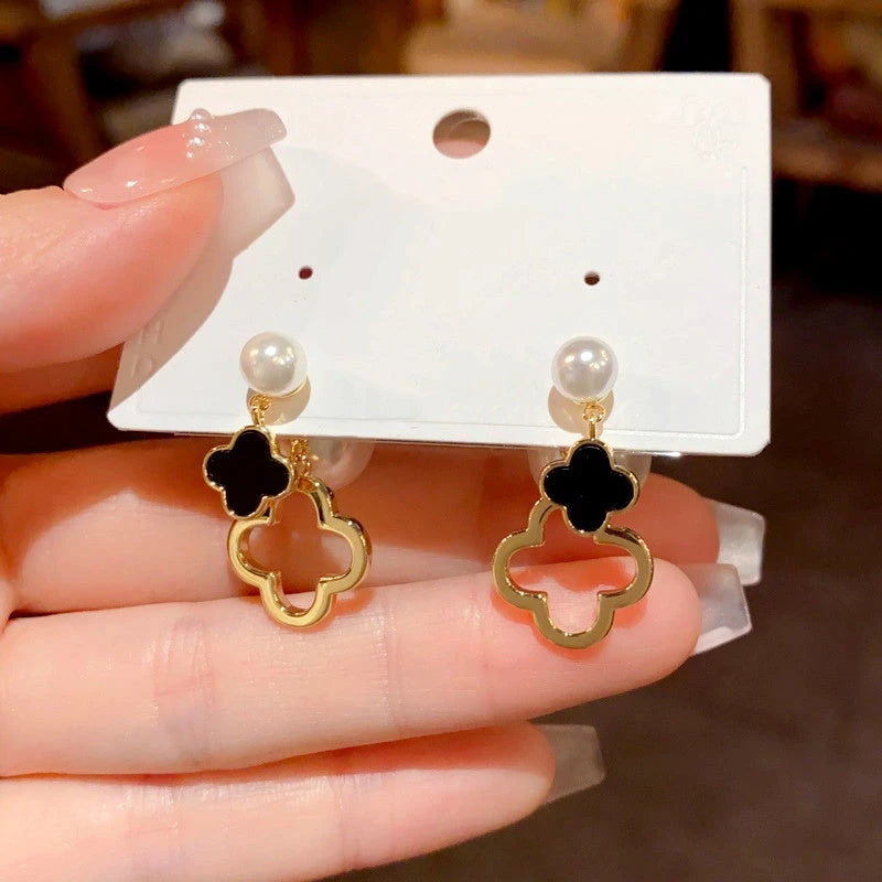 Angled view of the 14K Gold Plated Pearl Four-Leaf Flower Front And Back Earrings