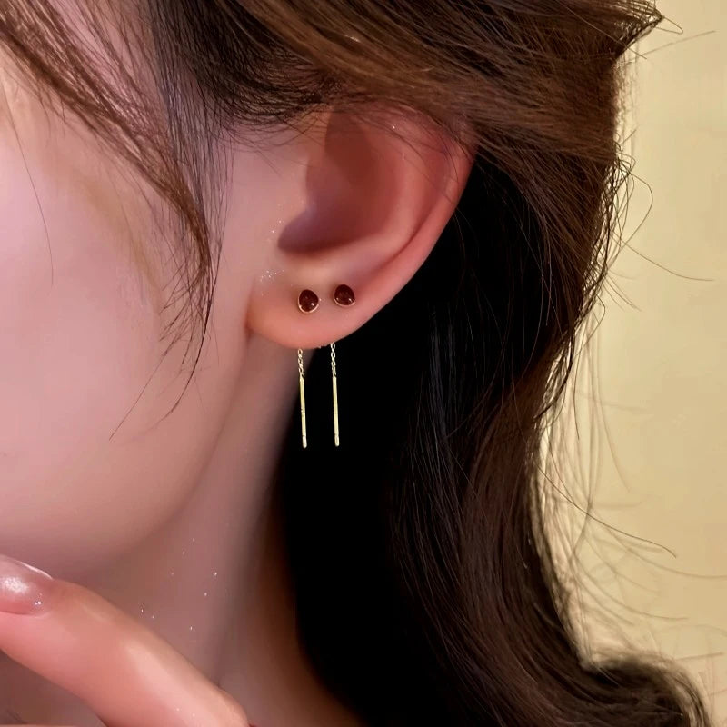 Close-up detail of the sparkling zircons and plating on the gold threader earrings