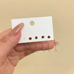 Angled view of the 14K Gold Plated Red Bean Threader Earrings